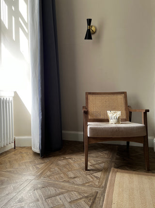 Lulu Lupin Coffee Packaging on wooden chair in a modern living room with sunlight coming through the window beige tones