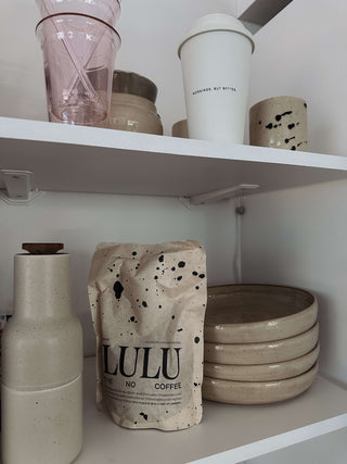 Lulu Lupine Coffee standing in a kitchen shelf in white an beige tones minimalistic kitchen.