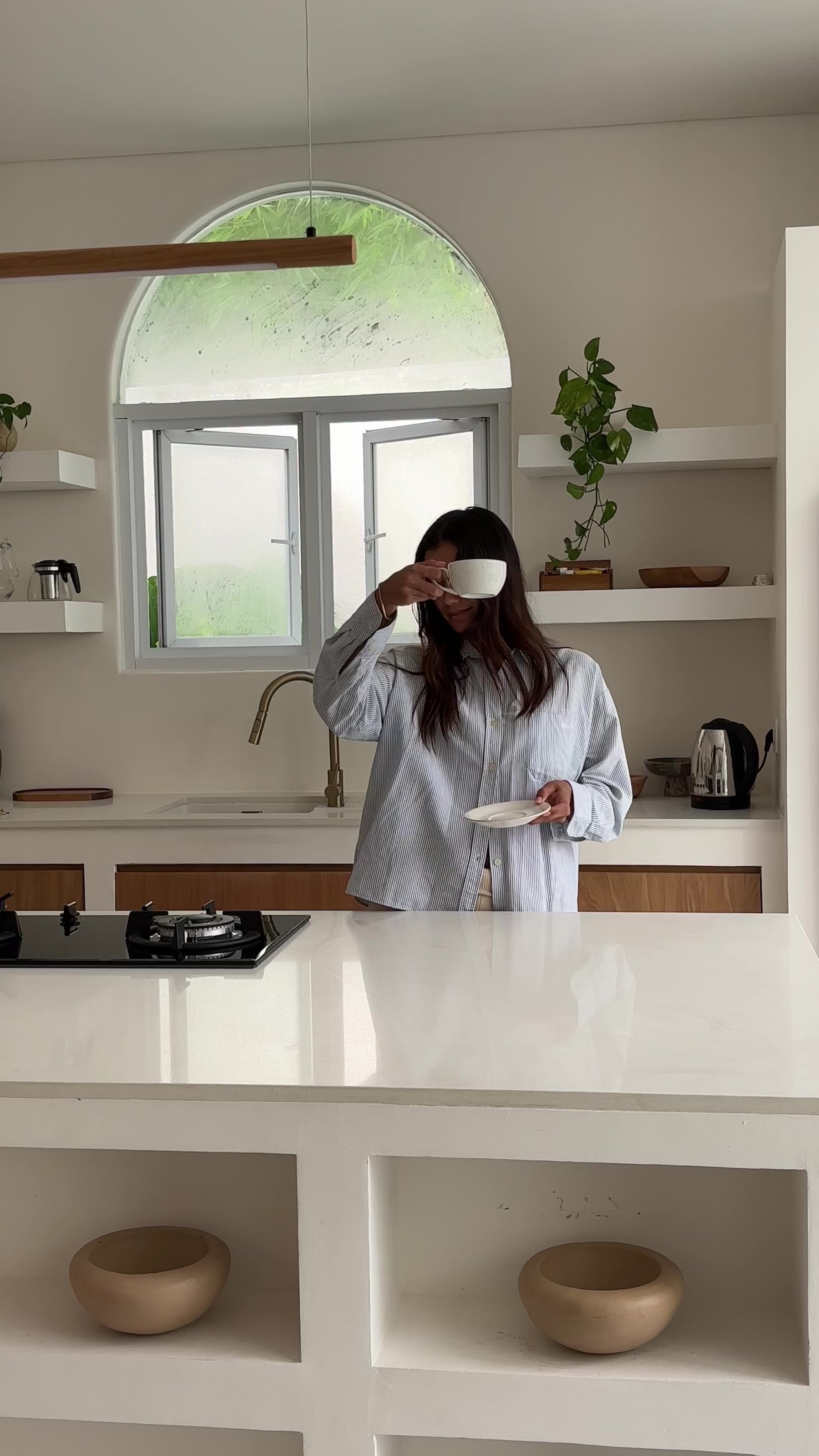Woman Holding A Cup Of Lulu In A Stunning Kitchen